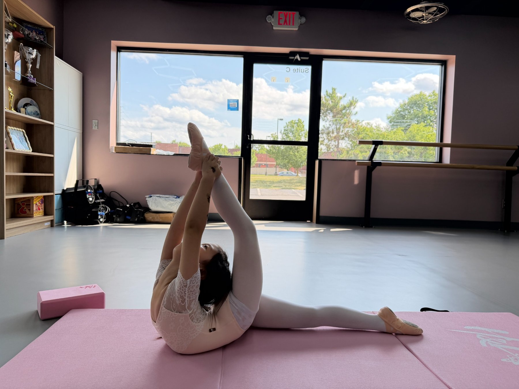 Young H&L dancer practicing flexibility and control in the new studio